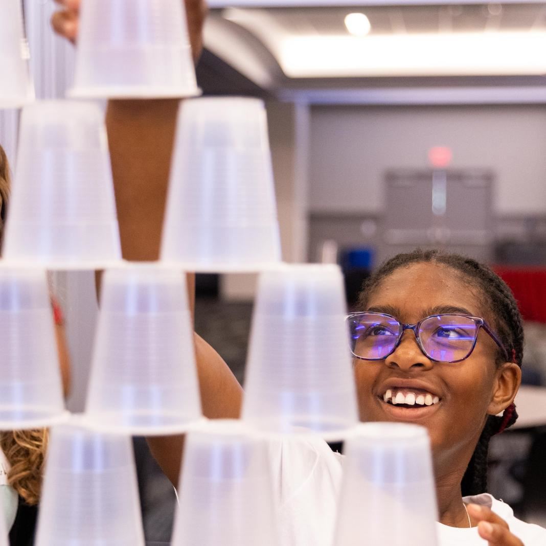  A student focuses on stacking cups